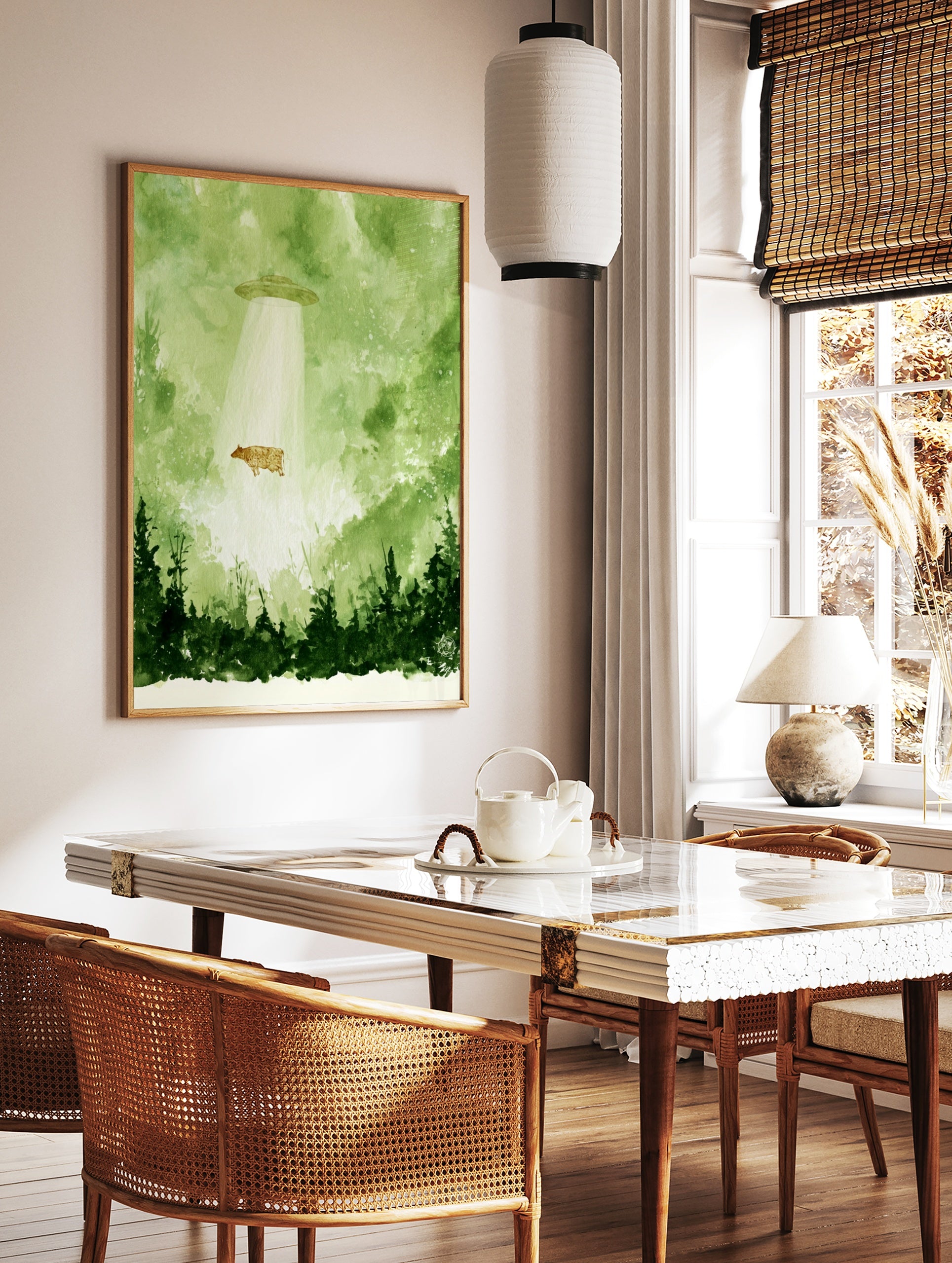 Watercolour illustration of a cow being abducted by a UFO in a green forest setting, in a styled room mockup
