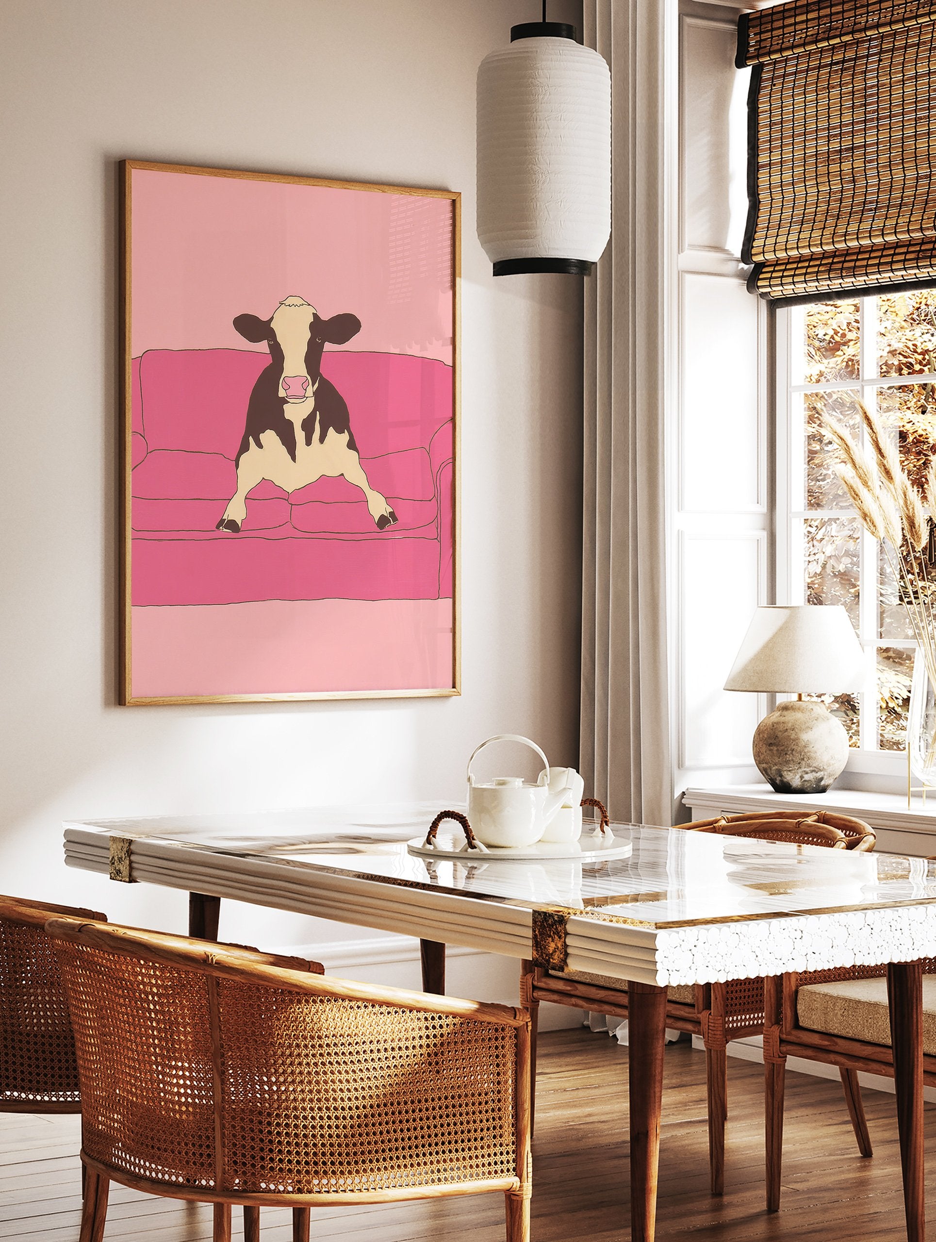 Illustrative art print of a black and white cow sitting on a pink couch against a pink background. - Image 2
