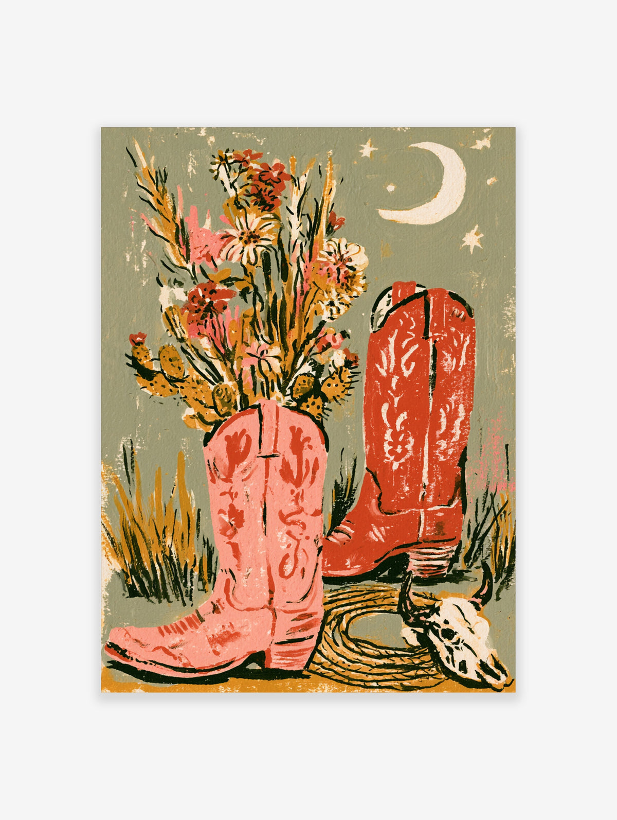 Pink cowboy boot vase with desert flowers beside red boot, rope, cow skull, and crescent moon