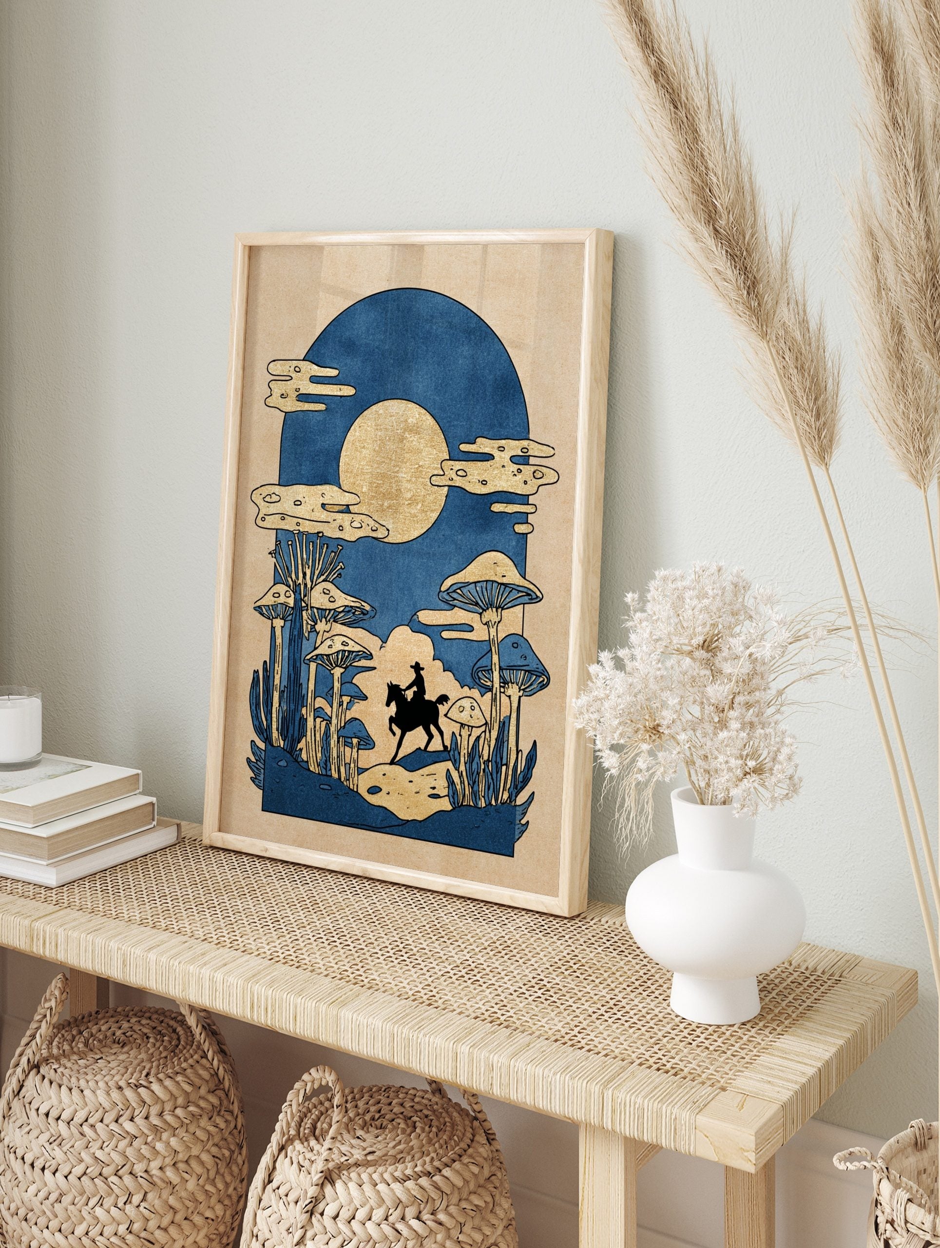 Illustrative print of cowboy on horse in mushroom forest under golden moon, blue and gold, in an alternate framed mockup
