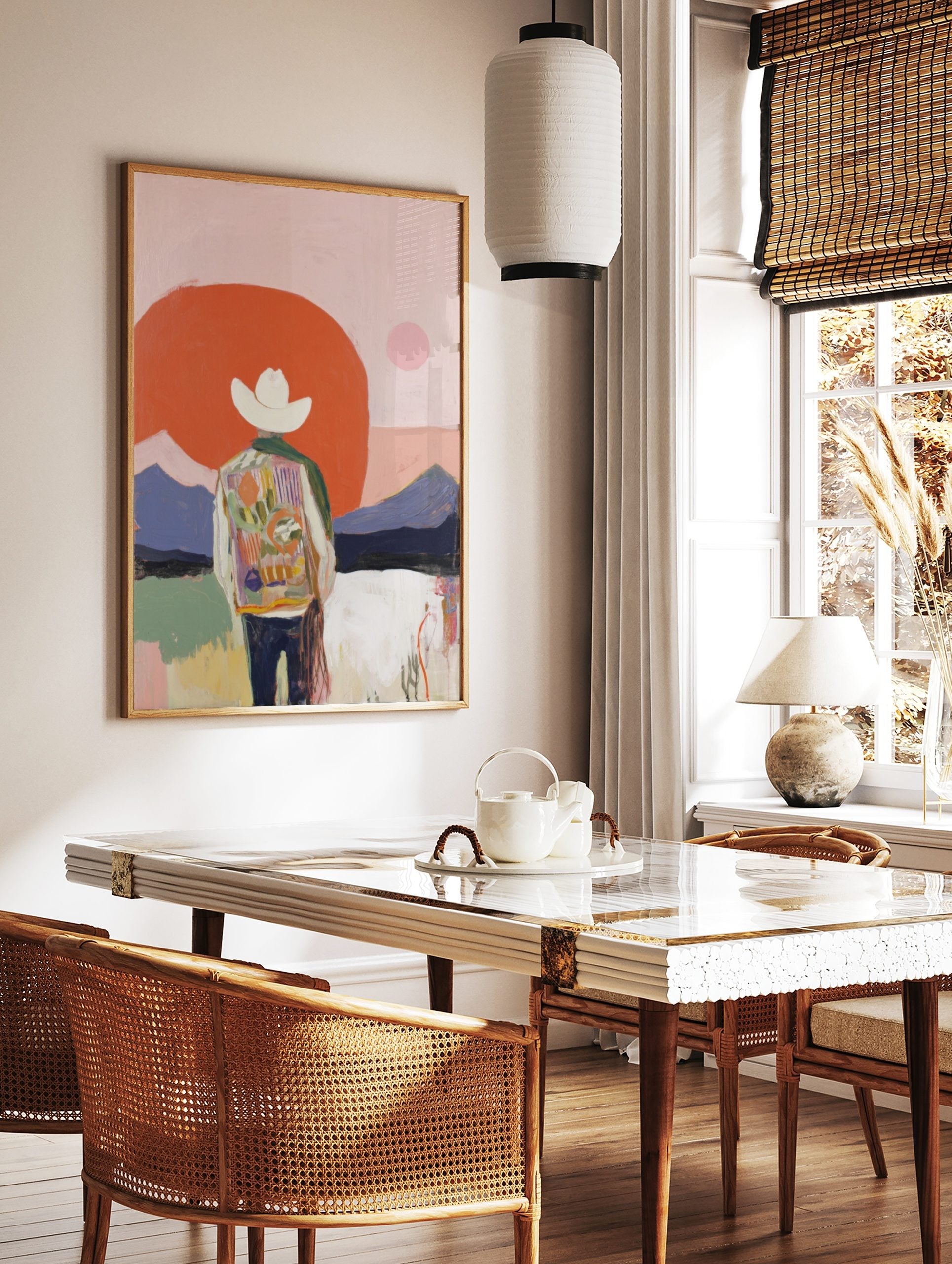 Abstract cowboy art print with figure in colourful jacket, white hat, red sun, and purple mountains, in a styled room mockup