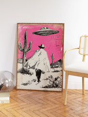 Illustrated Cowboy UFO art print featuring a cowboy in a pink desert with cacti and a flying saucer overhead. - Image 2