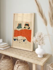 Illustrated Cozy Frogs in Bed wall art print featuring two frogs with headphones, popcorn, book, and mug on a nightstand. - Image 3