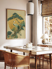 White-necked crane on pine tree branch against gold circle, Japanese illustrative art print, in a styled room mockup