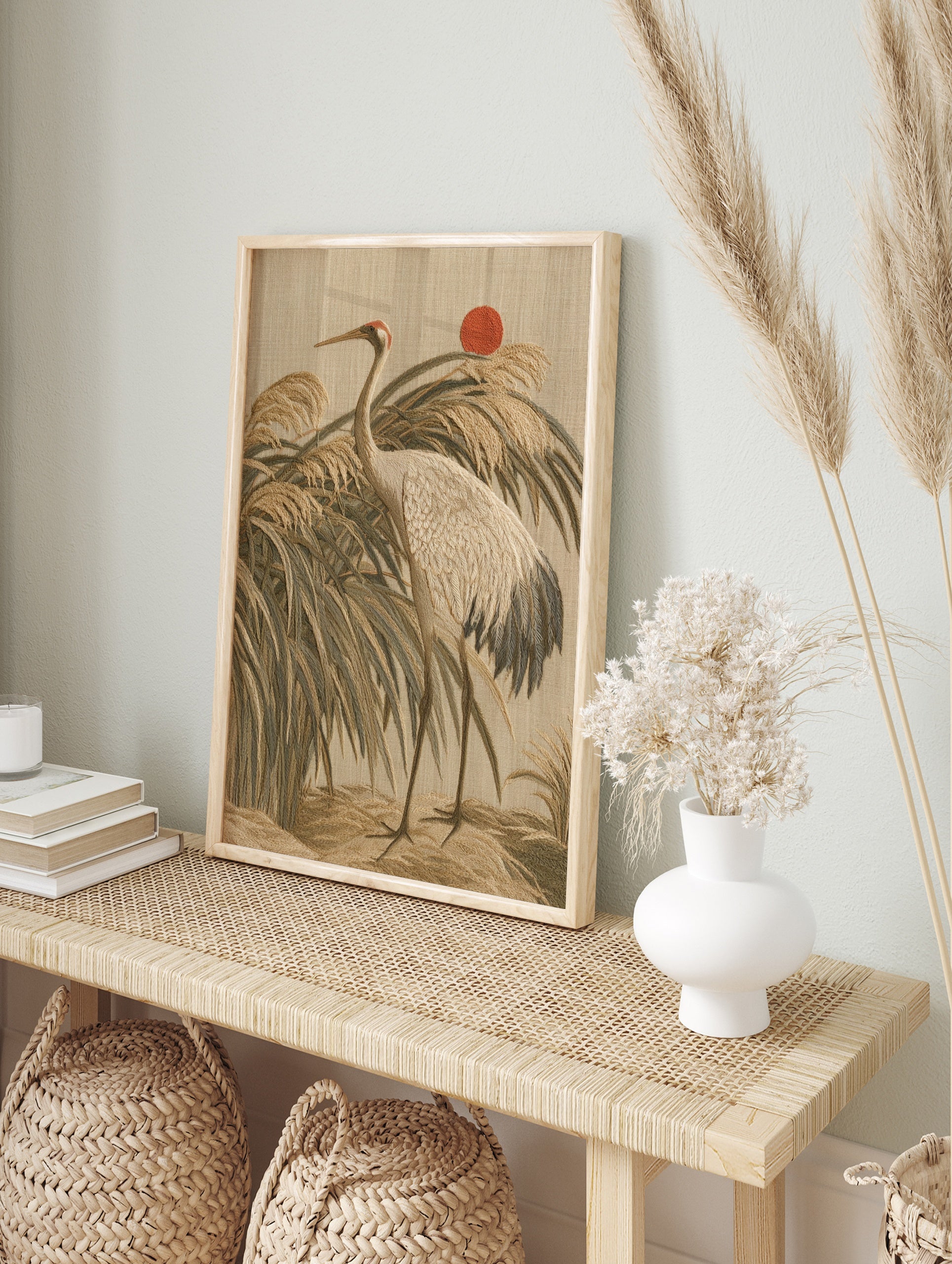 Japanese style crane bird wall art print featuring reeds and a red sun on a beige background, in an alternate framed mockup
