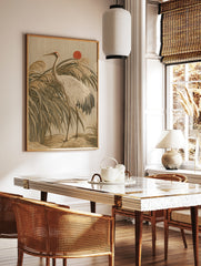 Japanese style crane bird wall art print featuring reeds and a red sun on a beige background, in a styled room mockup