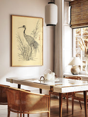 Japanese illustrative print of a crane bird standing in tall grass with a flowering branch on a, in a styled room mockup