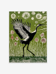 Black and white crane with widespread wings walking through green reeds and thistle plants in linocut style