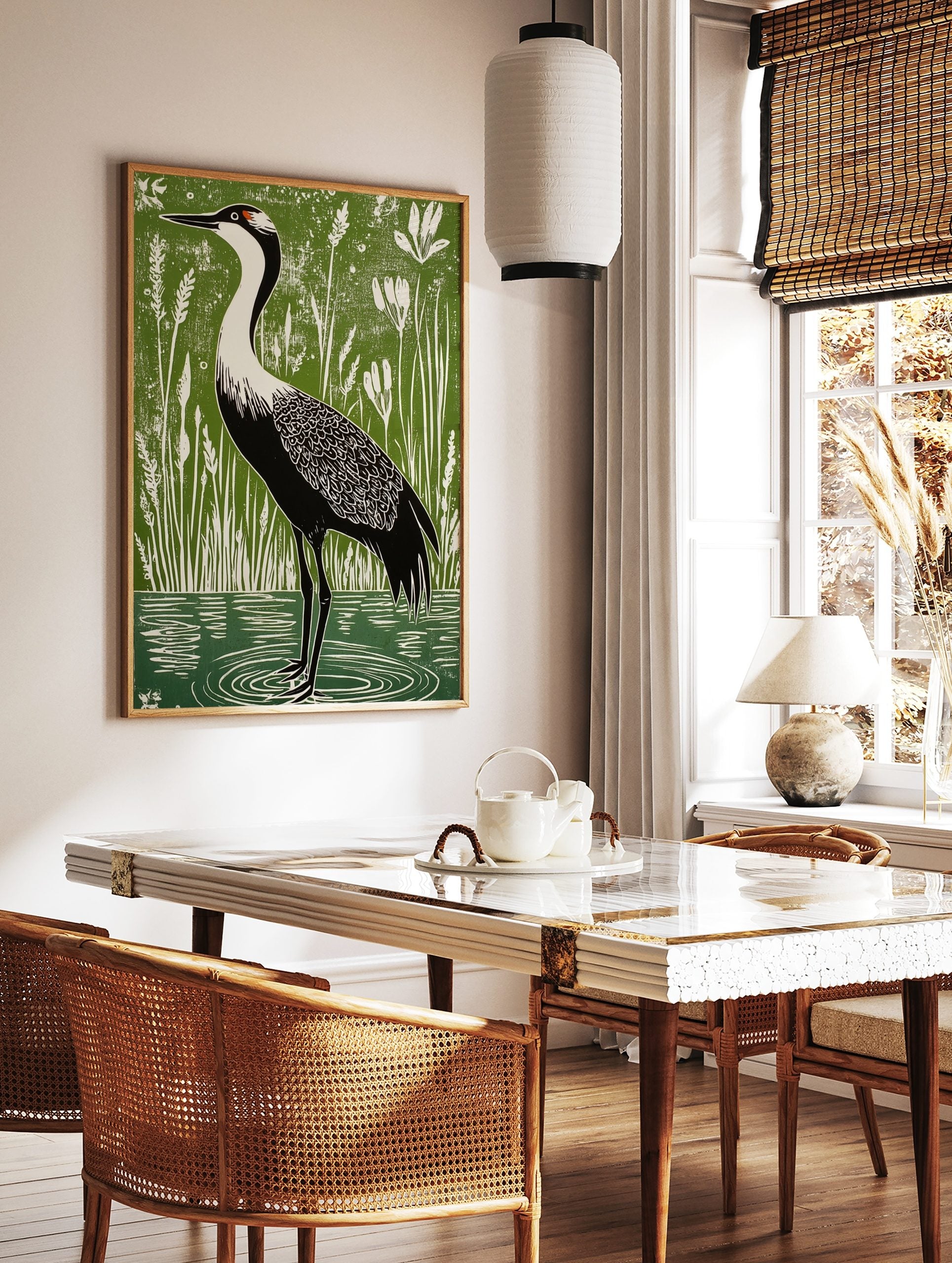 Linocut-style art print of a black and white crane with red head patch in green wetland with white, in a styled room mockup