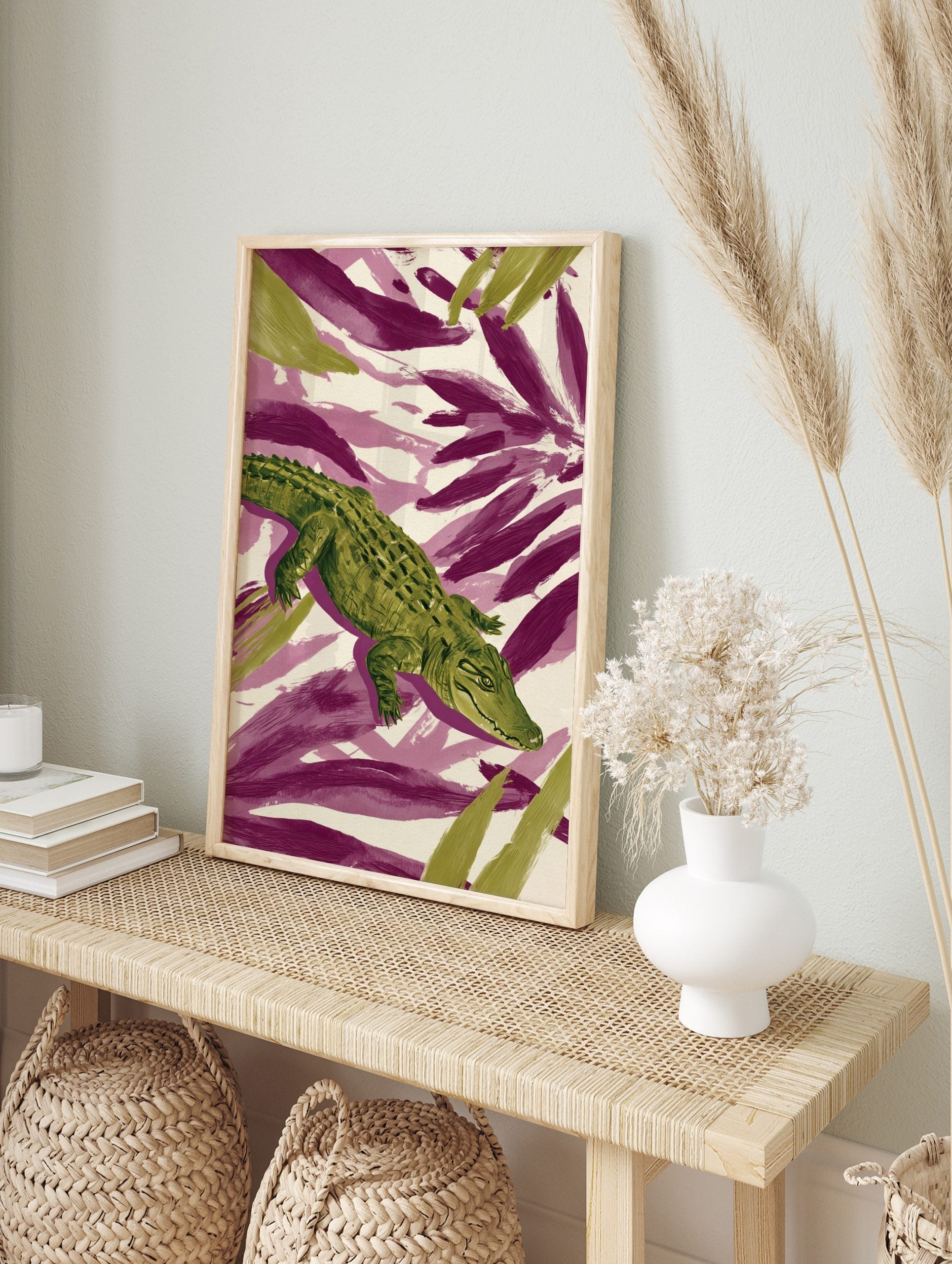 Green crocodile or alligator illustration with textured scales on a background of purple and, in an alternate framed mockup