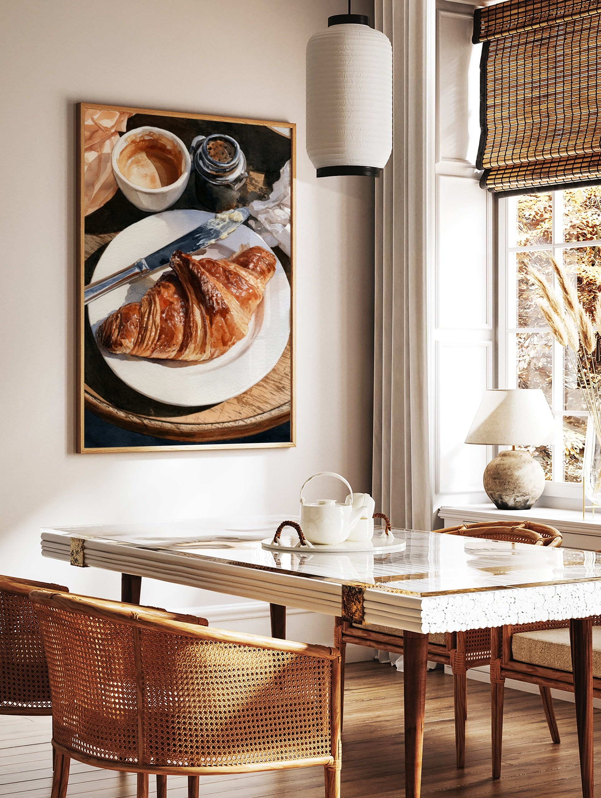 Watercolor painting of a croissant on a plate with coffee and a butter knife on a wooden table, in a styled room mockup