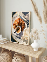 Watercolor illustration of a croissant, coffee cup, and butter knife on a plate, breakfast, in an alternate framed mockup