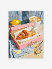 Croissant breakfast poster with a golden croissant in a pink box, fresh lemon, and a bowl of oats on a table.