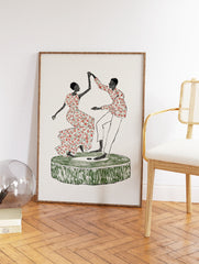 Cultural Dance Art print depicting an African couple dancing on a green platform with red and green patterned clothes. - Image 2
