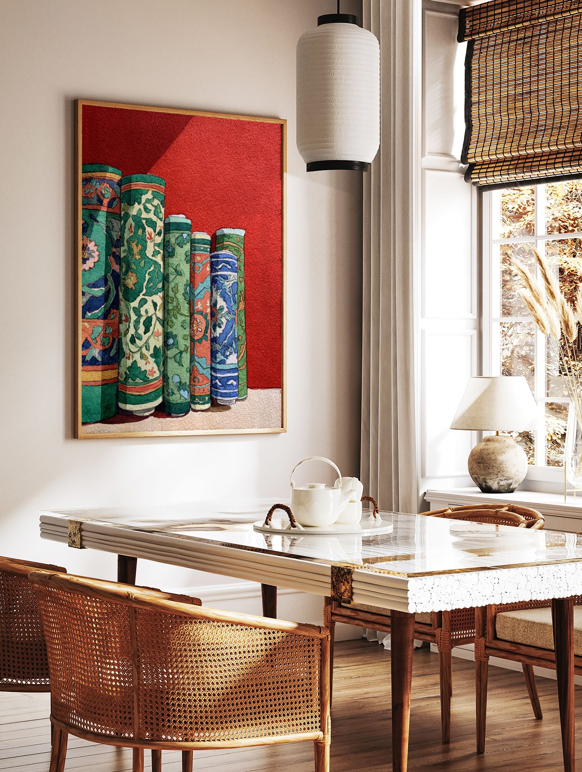 Cultural wall art print depicting several vibrantly patterned, rolled green, blue, and orange textiles against a red wall. - Image 2
