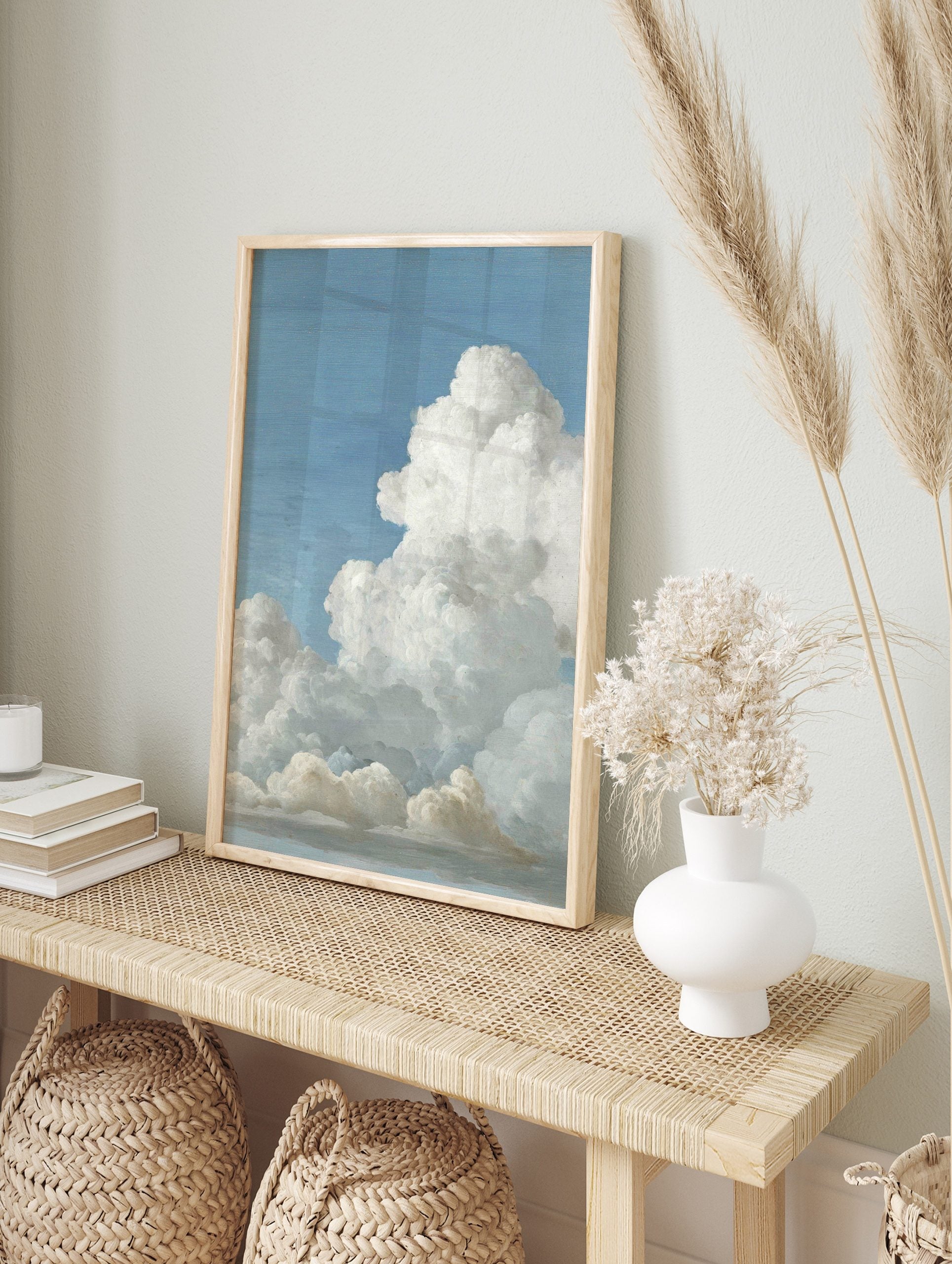 Realistic painting of fluffy white cumulus clouds against a bright blue sky, with subtle grey, in an alternate framed mockup