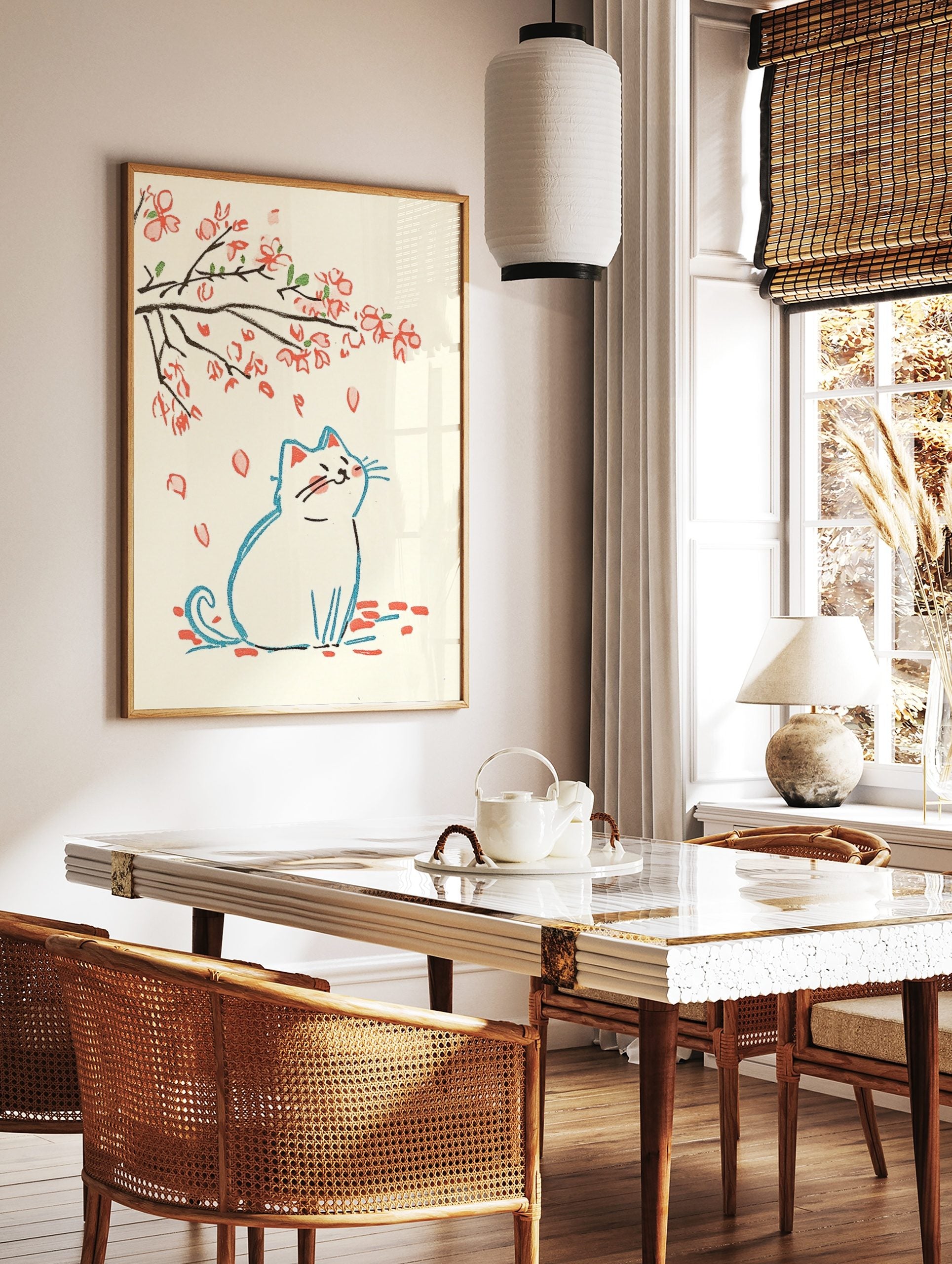 Illustrative print of a white cat looking up at falling pink cherry blossom petals and branches, in a styled room mockup