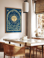 Cyanotype-style wall art with smiling sun, stars, and botanical leaves within an arched decorative, in a styled room mockup