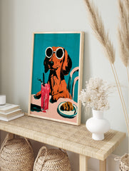 Dachshund in round sunglasses with a pink drink and croissant, illustrative style on a solid, in an alternate framed mockup