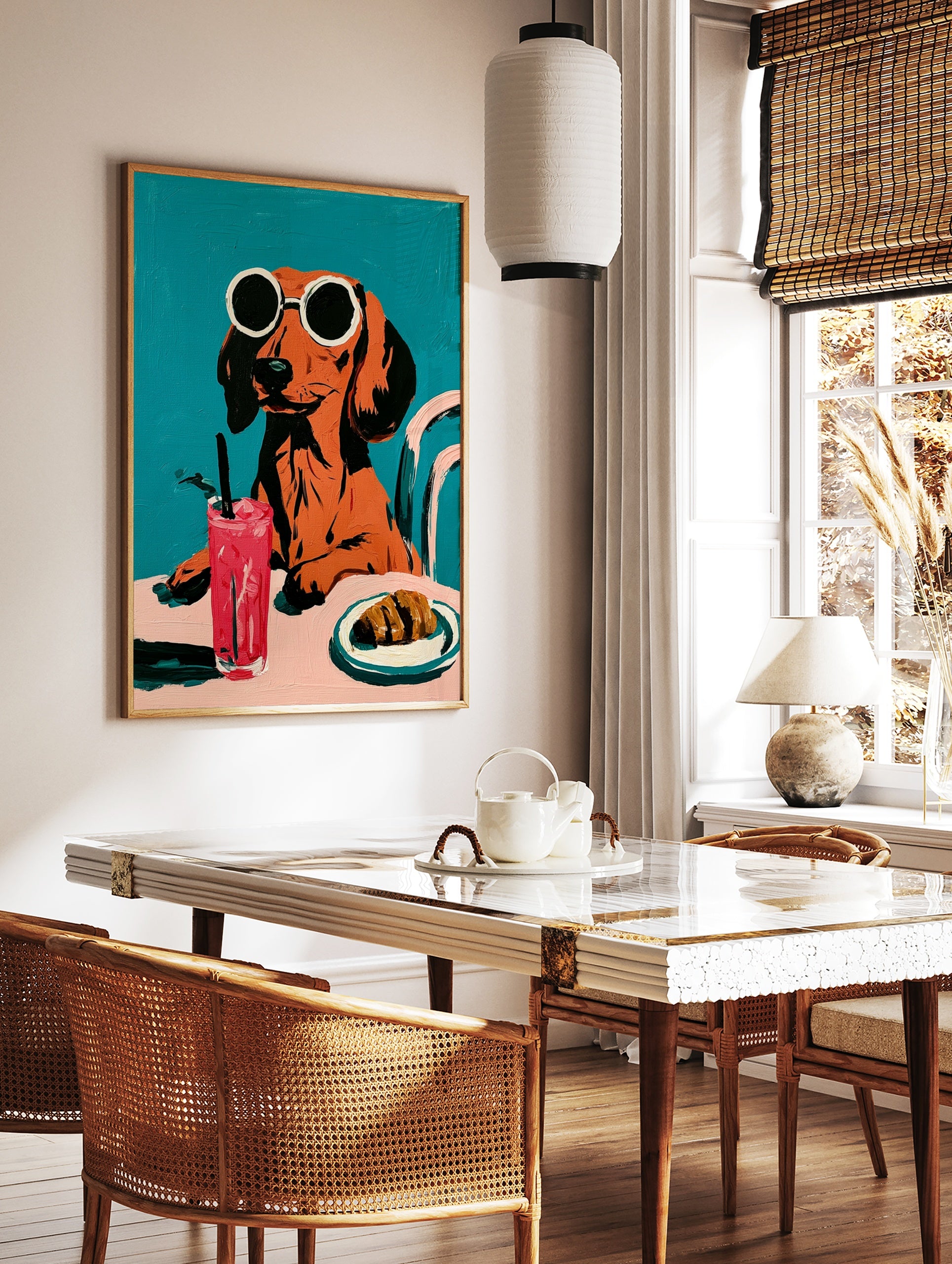 Dachshund in round sunglasses with a pink drink and croissant, illustrative style on a solid teal, in a styled room mockup