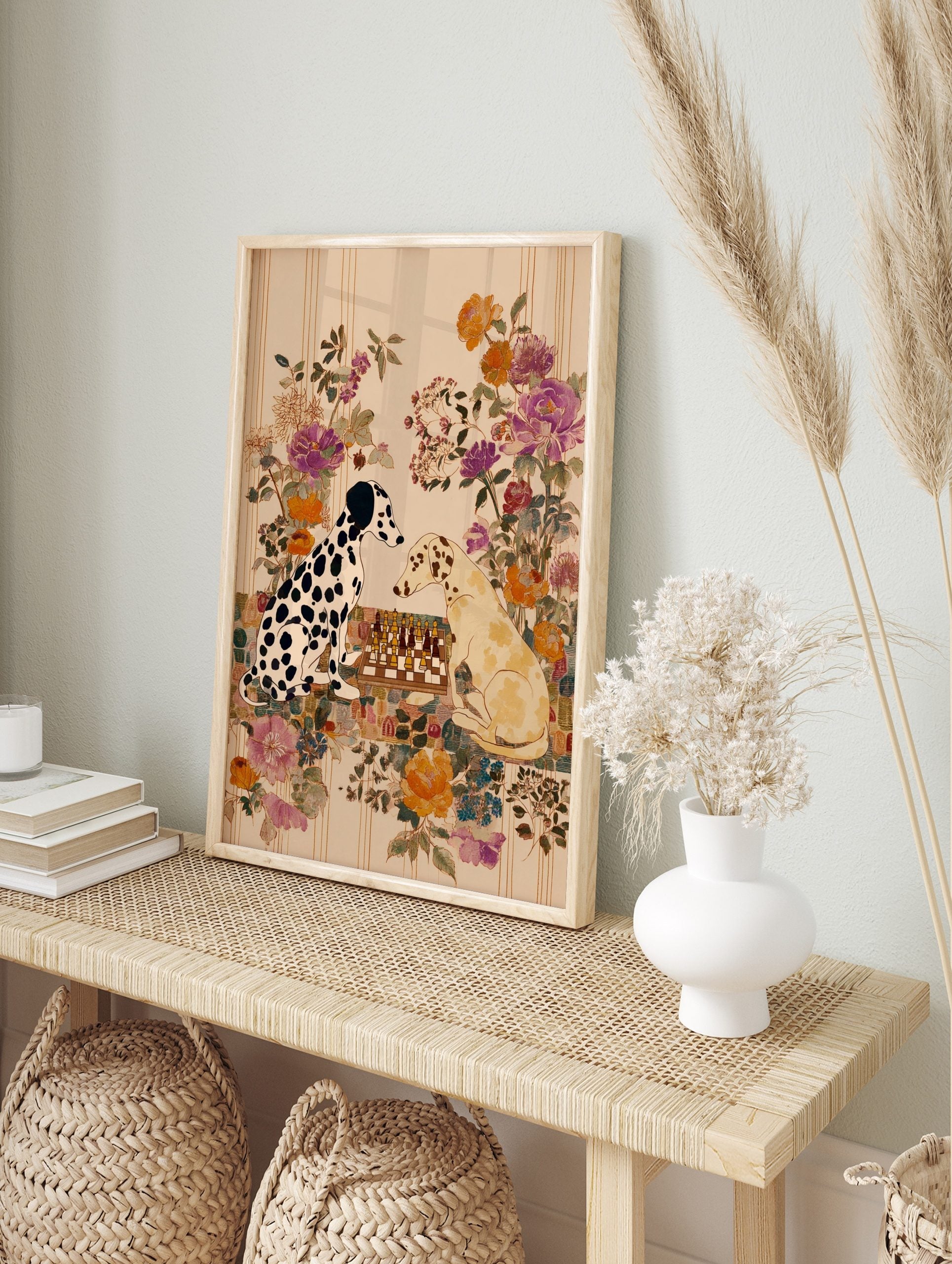 Illustrative art print of two Dalmatian dogs playing chess with a colourful floral background, in an alternate framed mockup