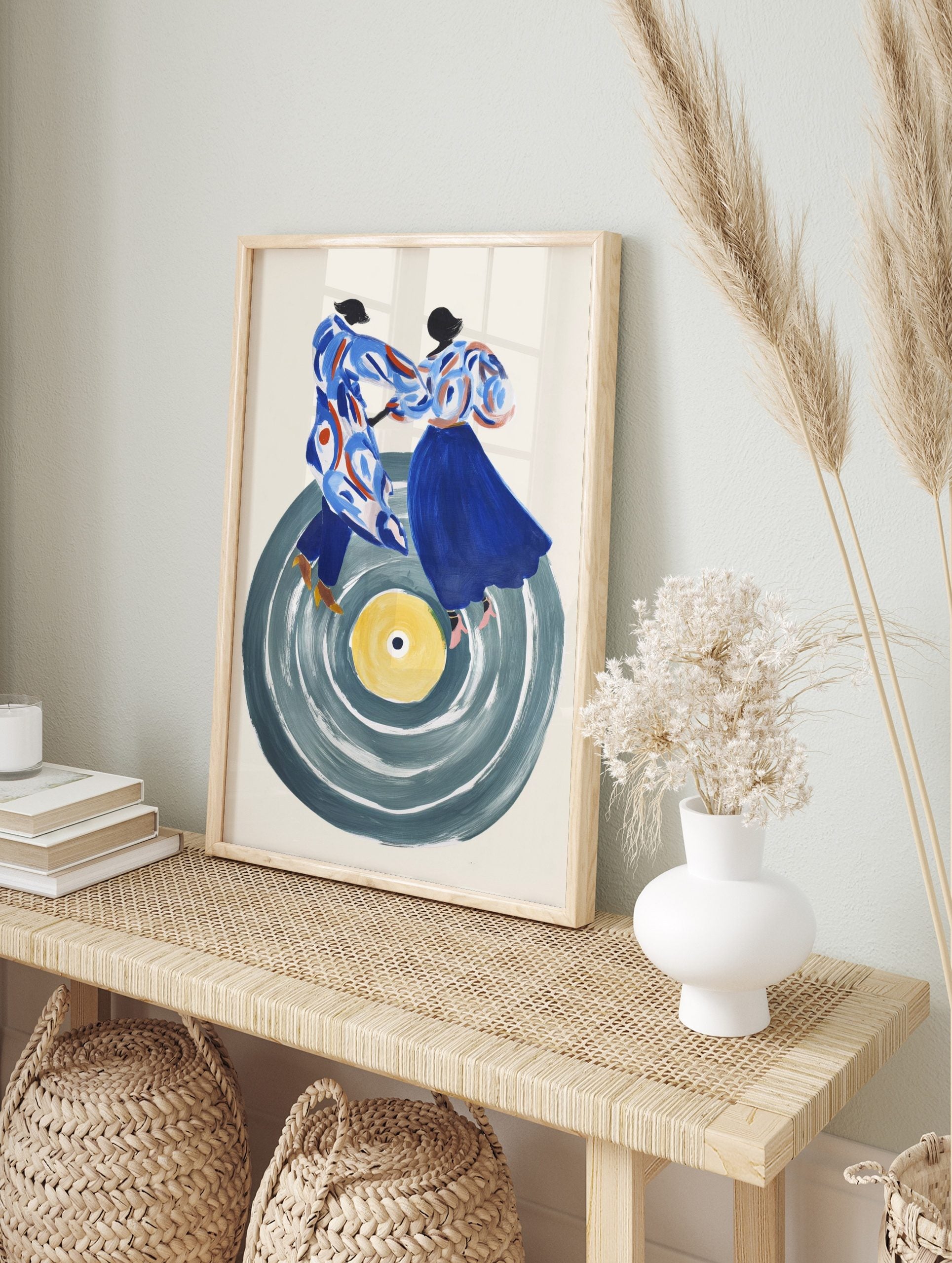 Illustrative art print of a dancing couple on a large grey vinyl record with a yellow centre, in an alternate framed mockup