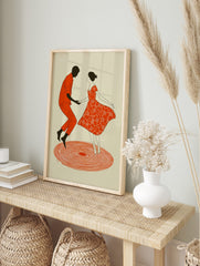 Illustrative art print of a dancing couple, man in orange, woman in red floral dress, on, in an alternate framed mockup