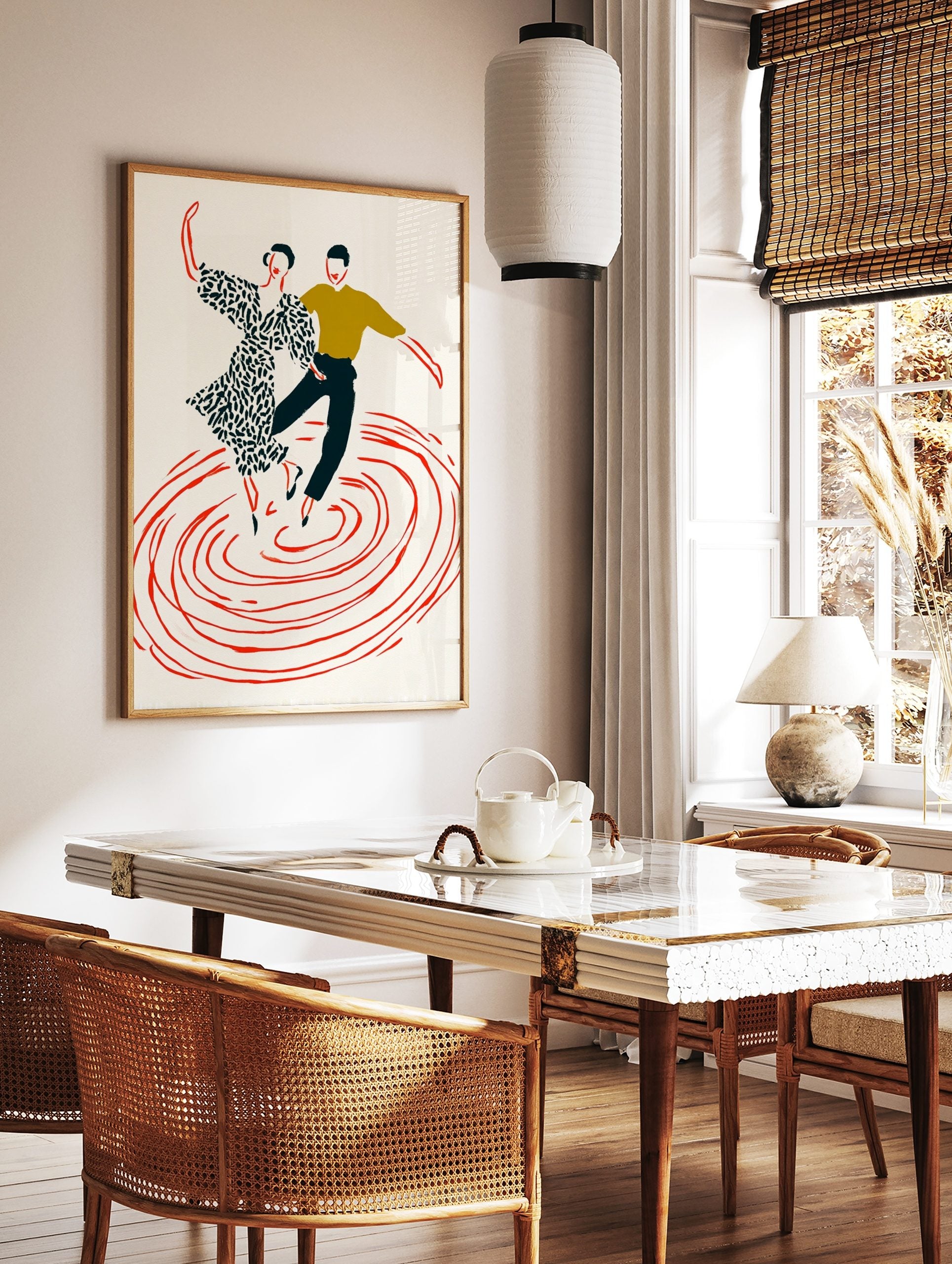 Illustrative print of two dancers, woman in patterned dress, man in olive top, above red swirling, in a styled room mockup