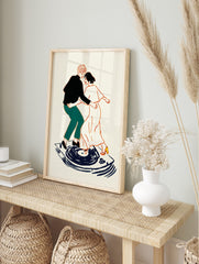 Illustrative art print of a couple dancing on a record player, outlined in orange with black, in an alternate framed mockup