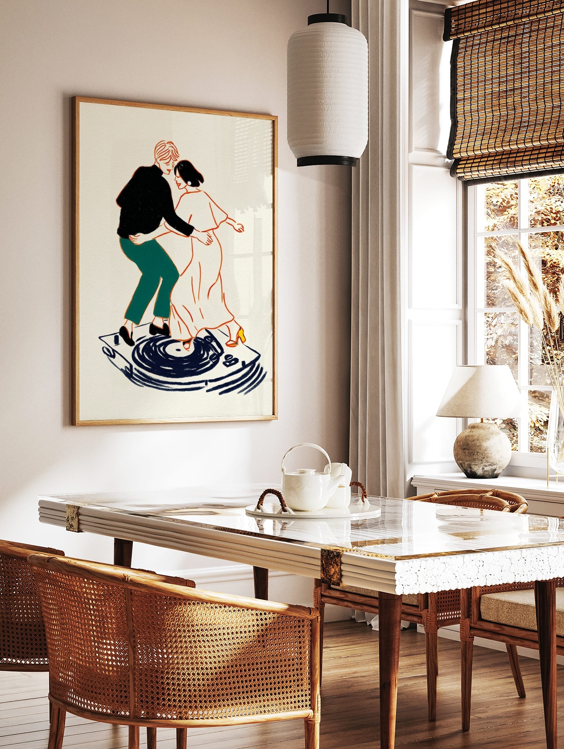 Illustrative art print of a couple dancing on a record player, outlined in orange with black, in a styled room mockup