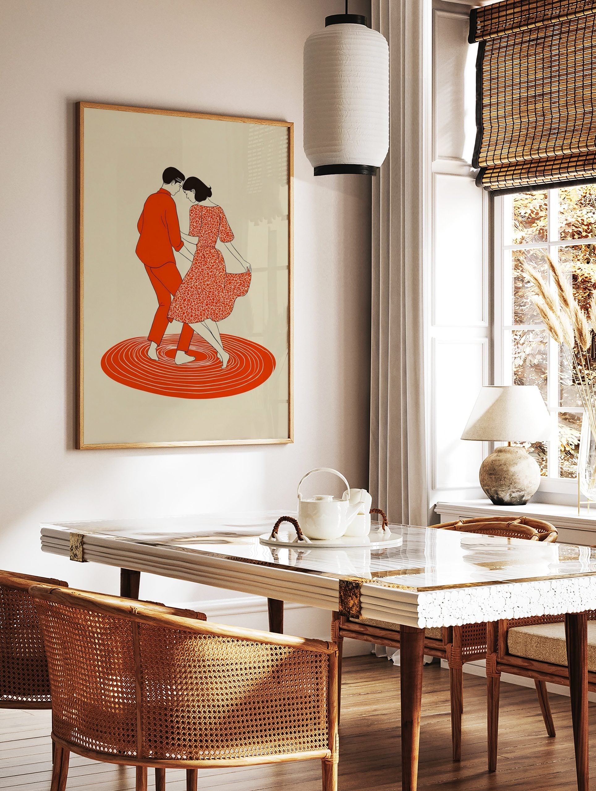 Illustrative print of a dancing couple in red, with a patterned dress and concentric circles on, in a styled room mockup
