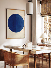Minimalist dark blue circle geometric wall art print on an off-white background with subtle, in a styled room mockup