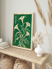 Botanical illustration of white Datura flowers with Japanese calligraphy on a deep green, in an alternate framed mockup