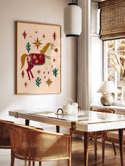 Illustrative decorated horse with red blanket, gold stars, and green cacti on a peach background, in a styled room mockup