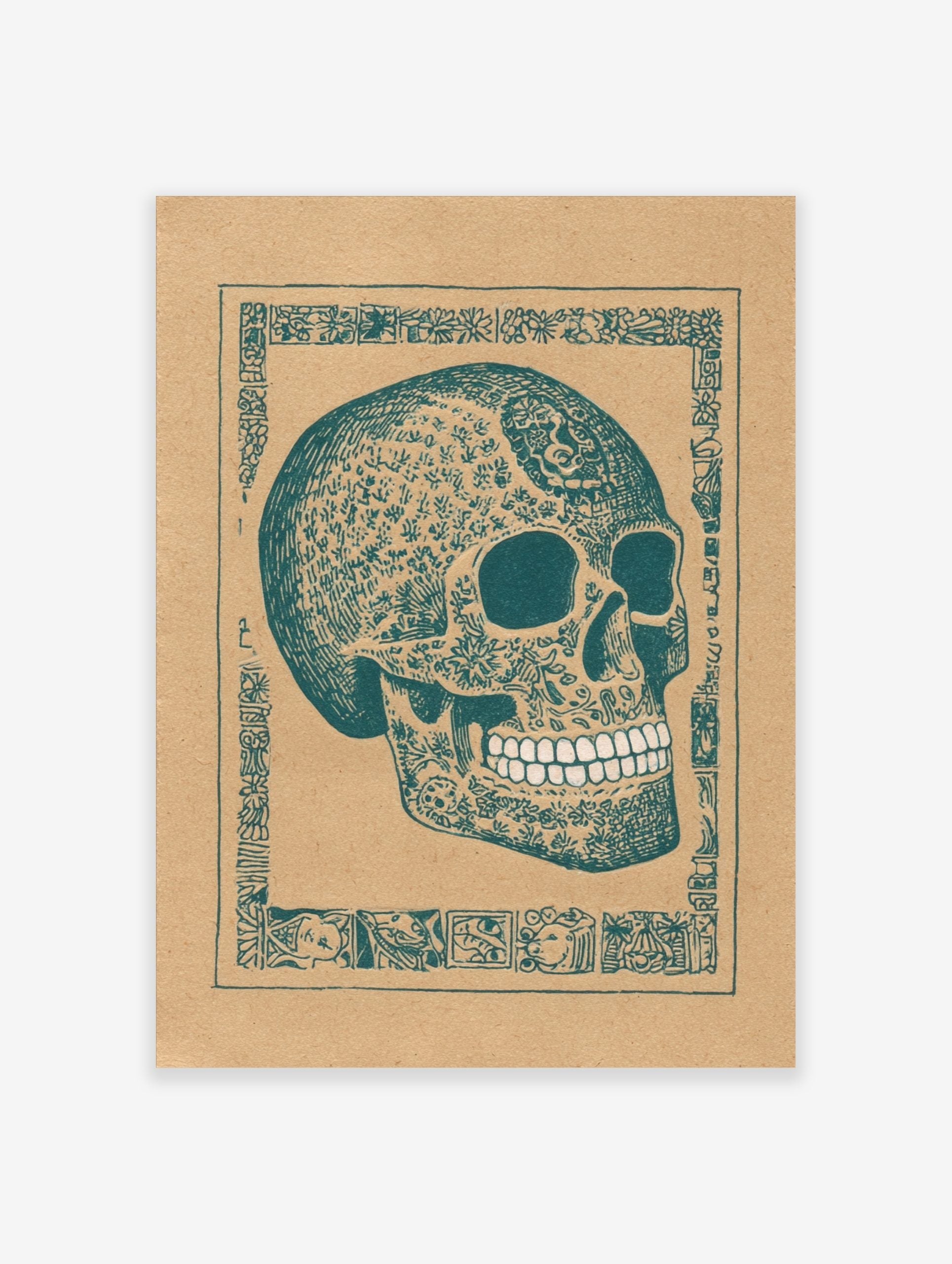 Decorated skull art print with intricate teal patterns on brown paper, framed by an ornate border