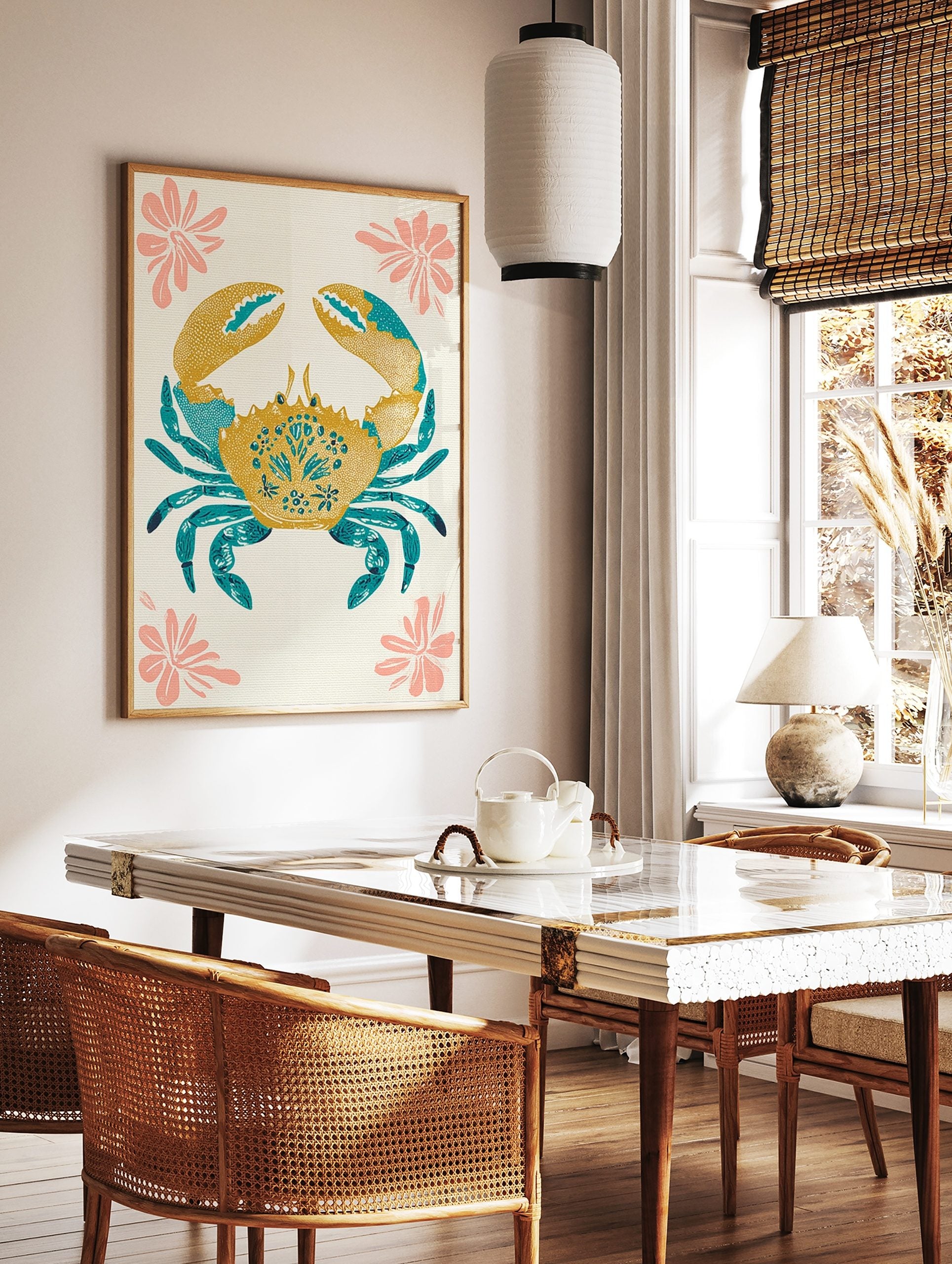 Decorative crab illustration wall art in golden yellow and teal blue with pink flowers on an, in a styled room mockup