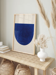 Deep blue abstract geometric art print with textured semicircle and horizontal lines on, in an alternate framed mockup