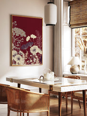 Deep red background with cream and white illustrative botanical poppy flowers and delicate foliage, in a styled room mockup