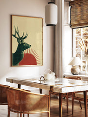 Illustrative green deer with antlers in profile against red sun on textured beige background, in a styled room mockup