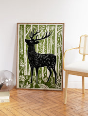 Black deer art print in a linocut style, standing in a green and white forest with stylized trees and foliage. - Image 2