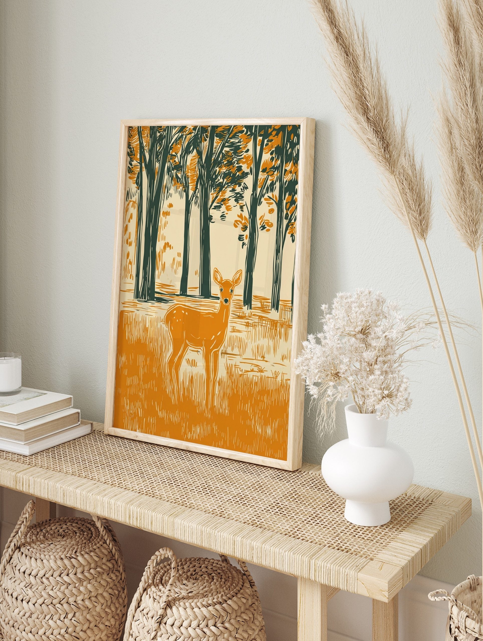 Woodcut style illustration of an orange deer in a dark green forest clearing with tall trees, in an alternate framed mockup