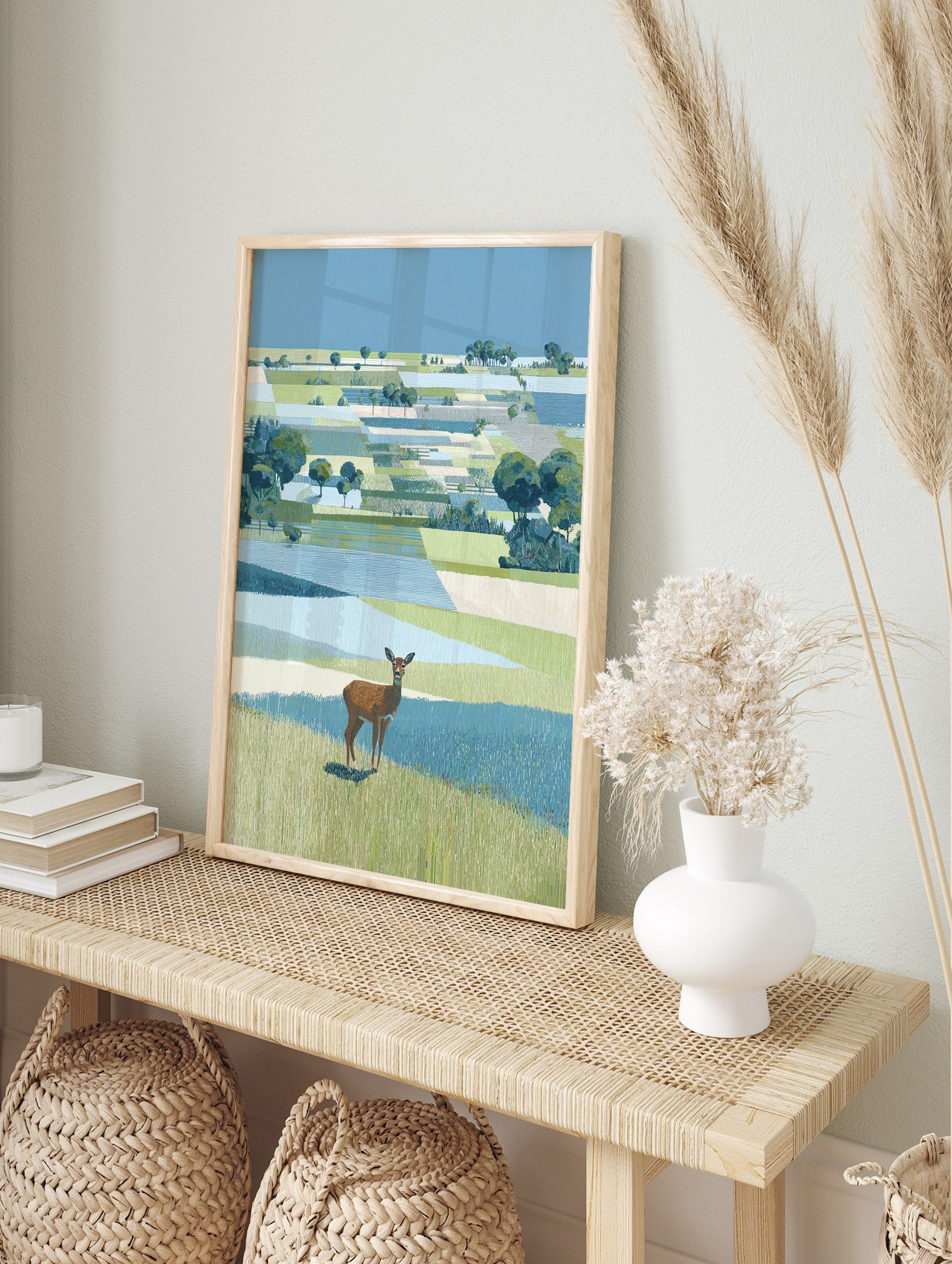 Illustrative landscape wall art featuring a brown deer standing in green and blue patterned fields under a clear blue sky. - Image 3