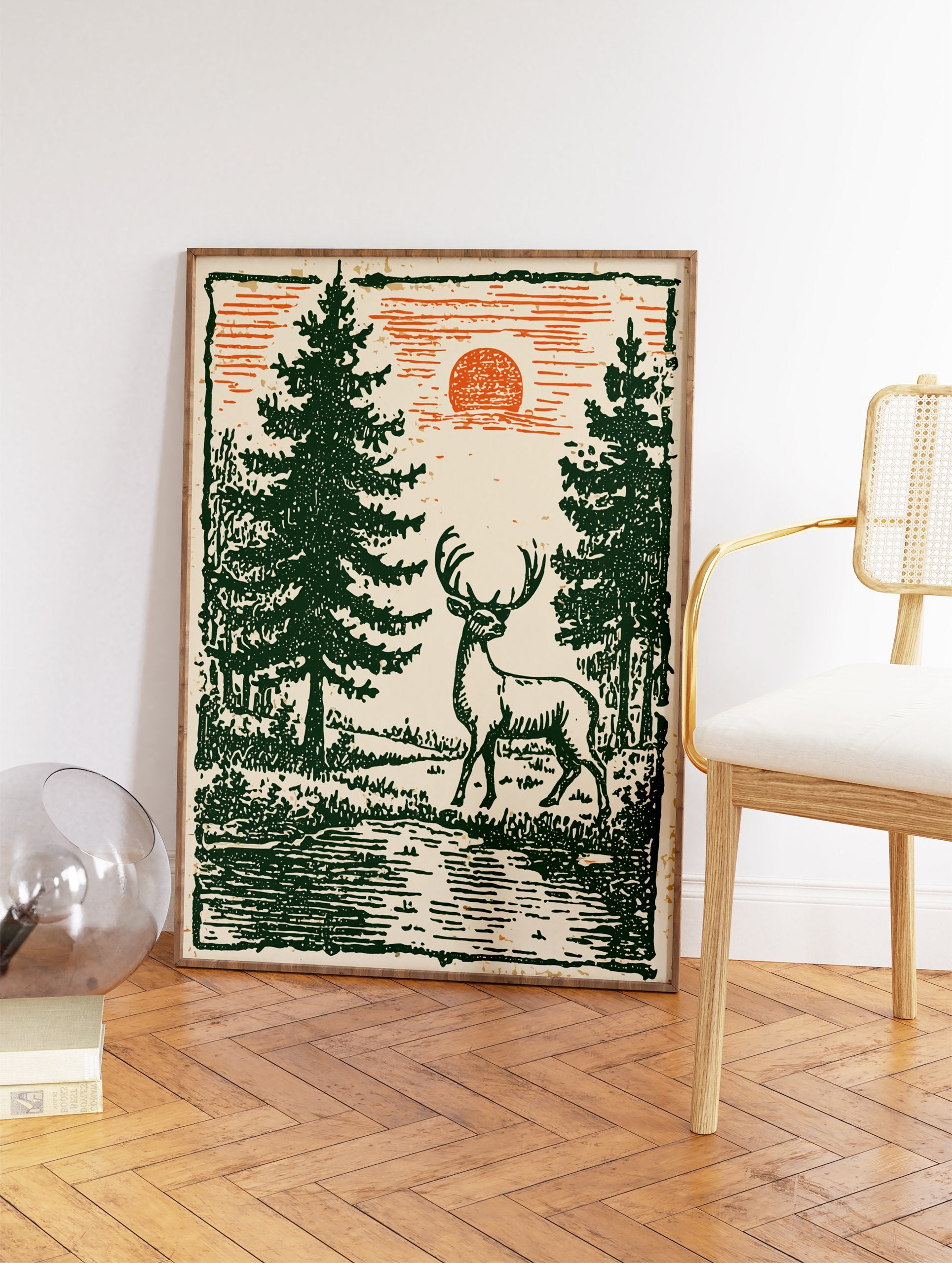 Vintage deer wall art featuring a stag in a green forest with pine trees and an orange sun in a woodcut illustration style. - Image 2