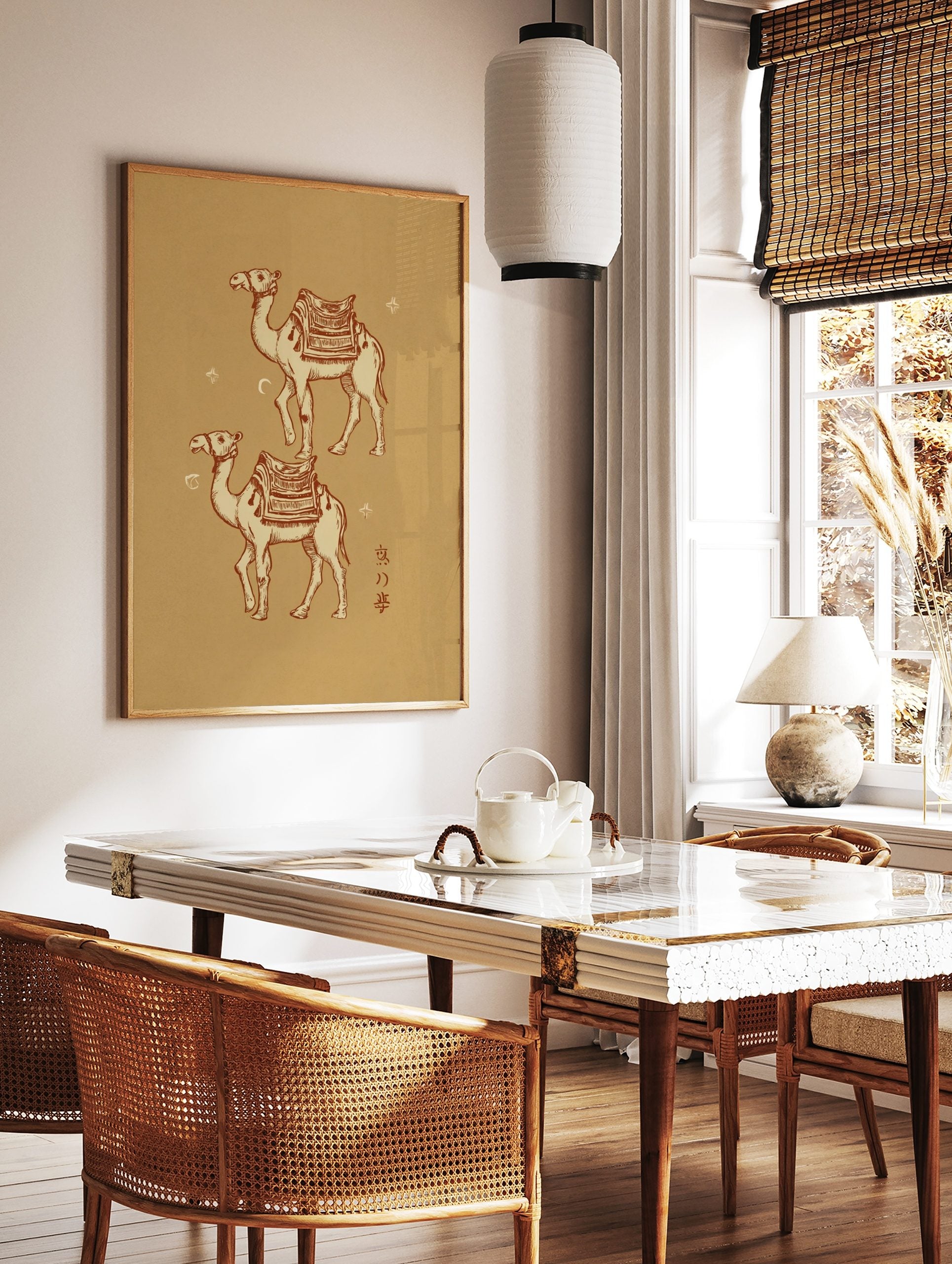 Two illustrated desert camels with decorative saddles, crescent moon, and stars on a beige, in a styled room mockup