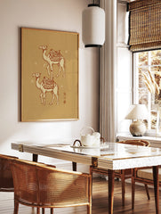 Two illustrated desert camels with decorative saddles, crescent moon, and stars on a beige, in a styled room mockup