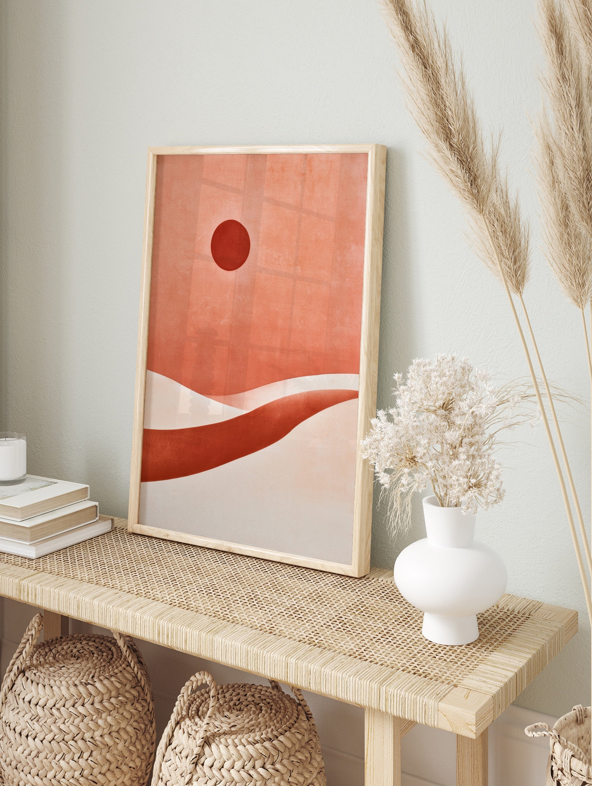 Abstract desert landscape with a dark red sun and layered terracotta sand dunes in a, in an alternate framed mockup
