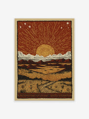 Desert Sun Linocut Poster depicting a sunset/sunrise over a vast landscape with mountains, clouds, and a path through grass.