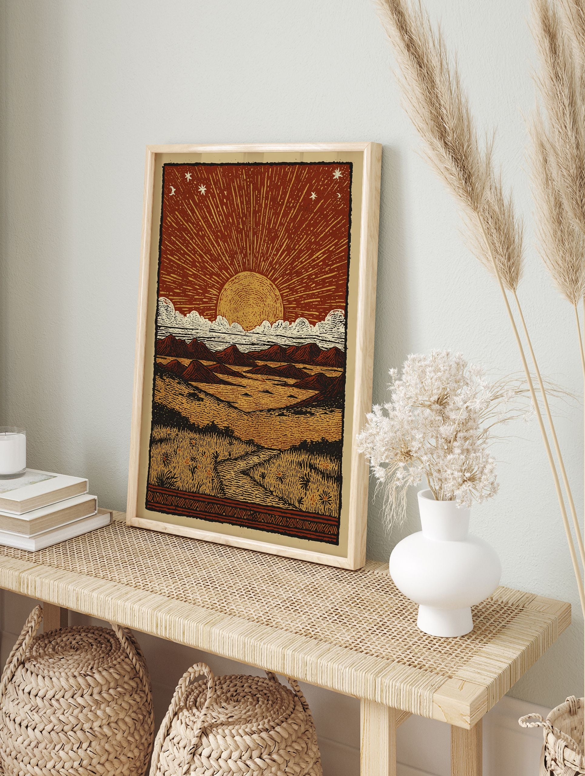 Desert Sun Linocut Poster depicting a sunset/sunrise over a vast landscape with mountains, clouds, and a path through grass. - Image 4