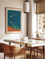 Illustrative green dinosaur looking up at a bright meteor streaking across a dark blue sky and, in a styled room mockup