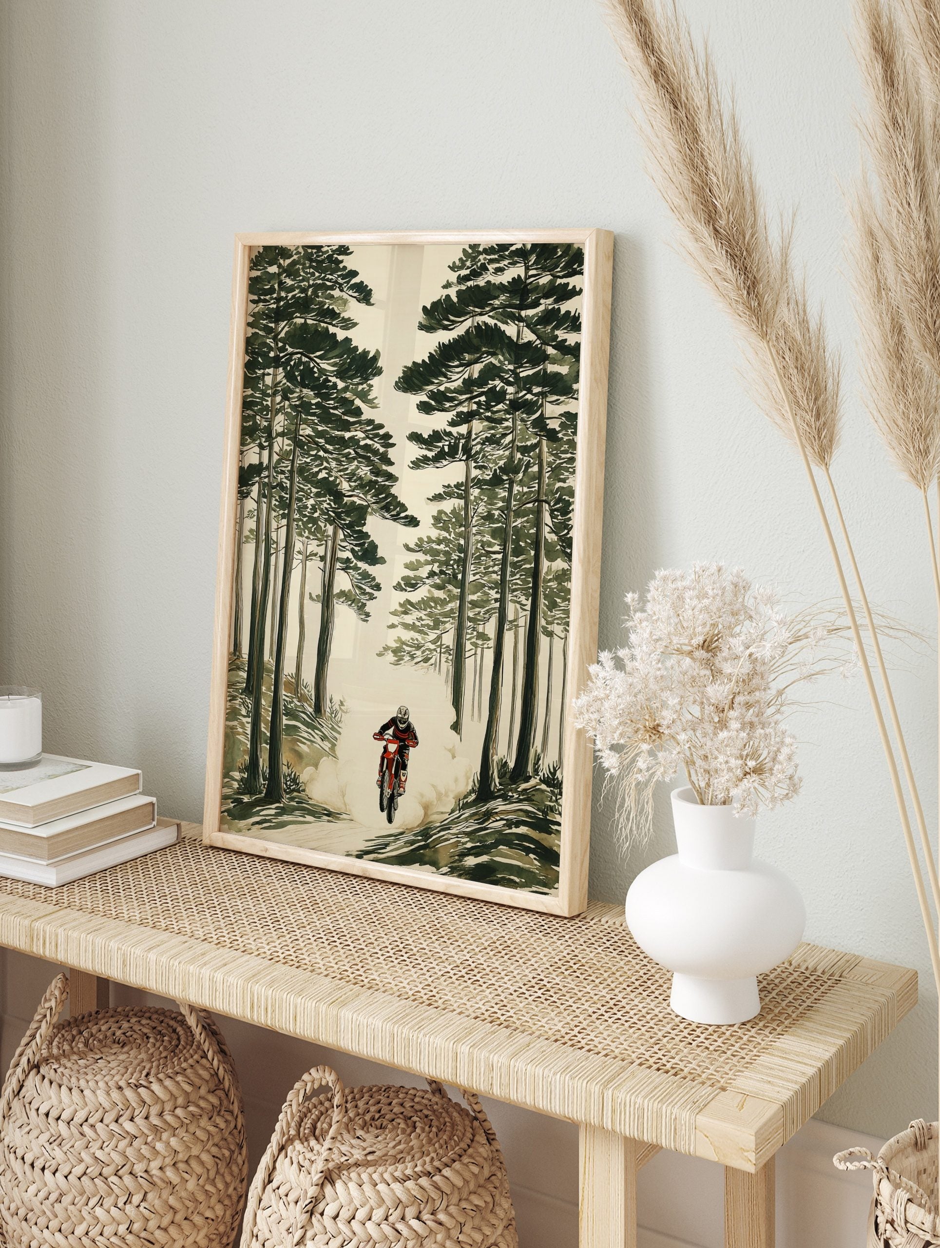 Illustrative print of a motocross rider on a red dirt bike, kicking up dust in a tall green, in an alternate framed mockup